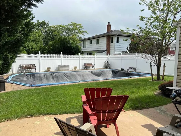 a view of a house with a yard patio and sitting area