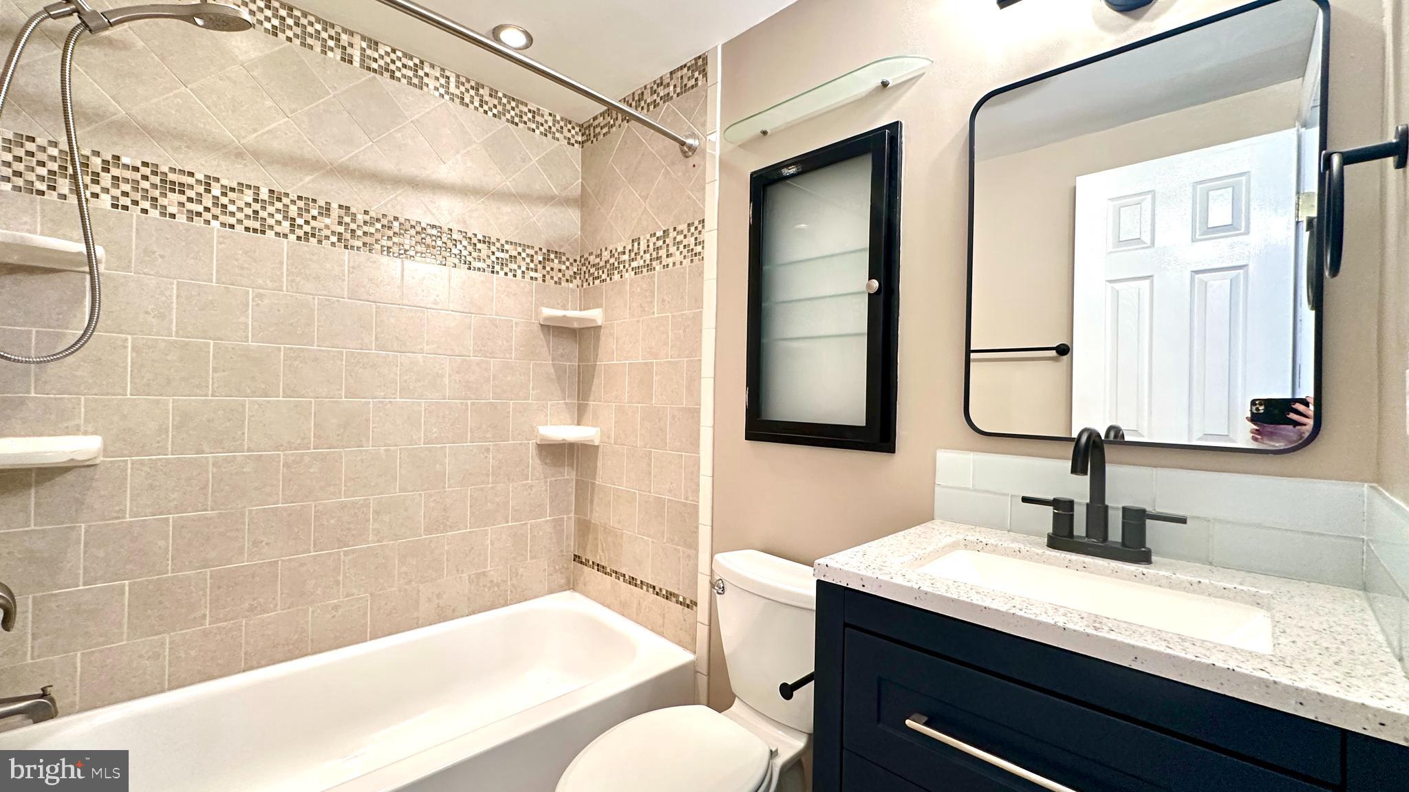 3423 Santee Road Nottingham, MD 21236 - Photo 13 of 30 a bathroom with a granite countertop sink a mirror and shower