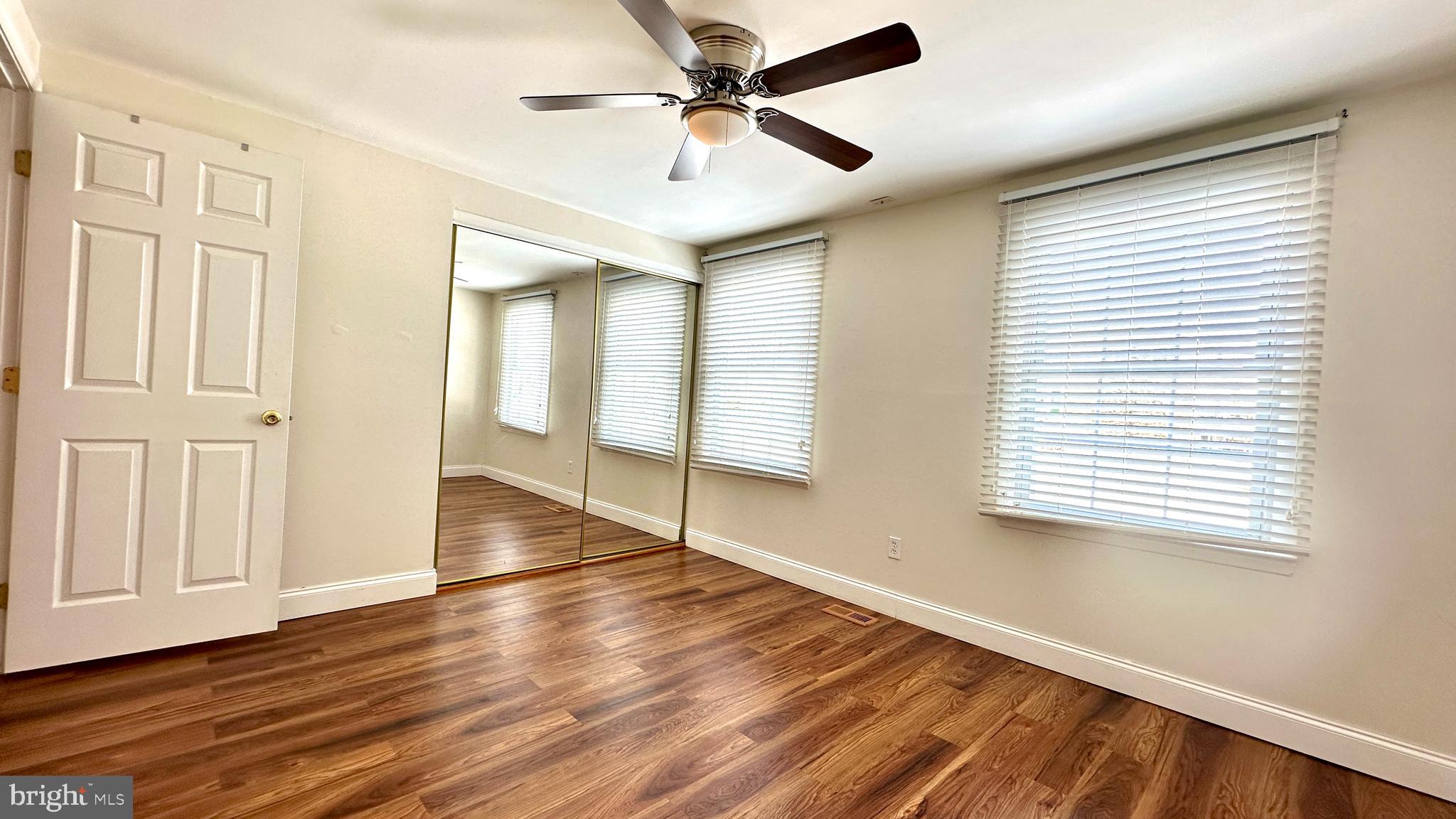 3423 Santee Road Nottingham, MD 21236 - Photo 14 of 30 a view of empty room with wooden floor and fan