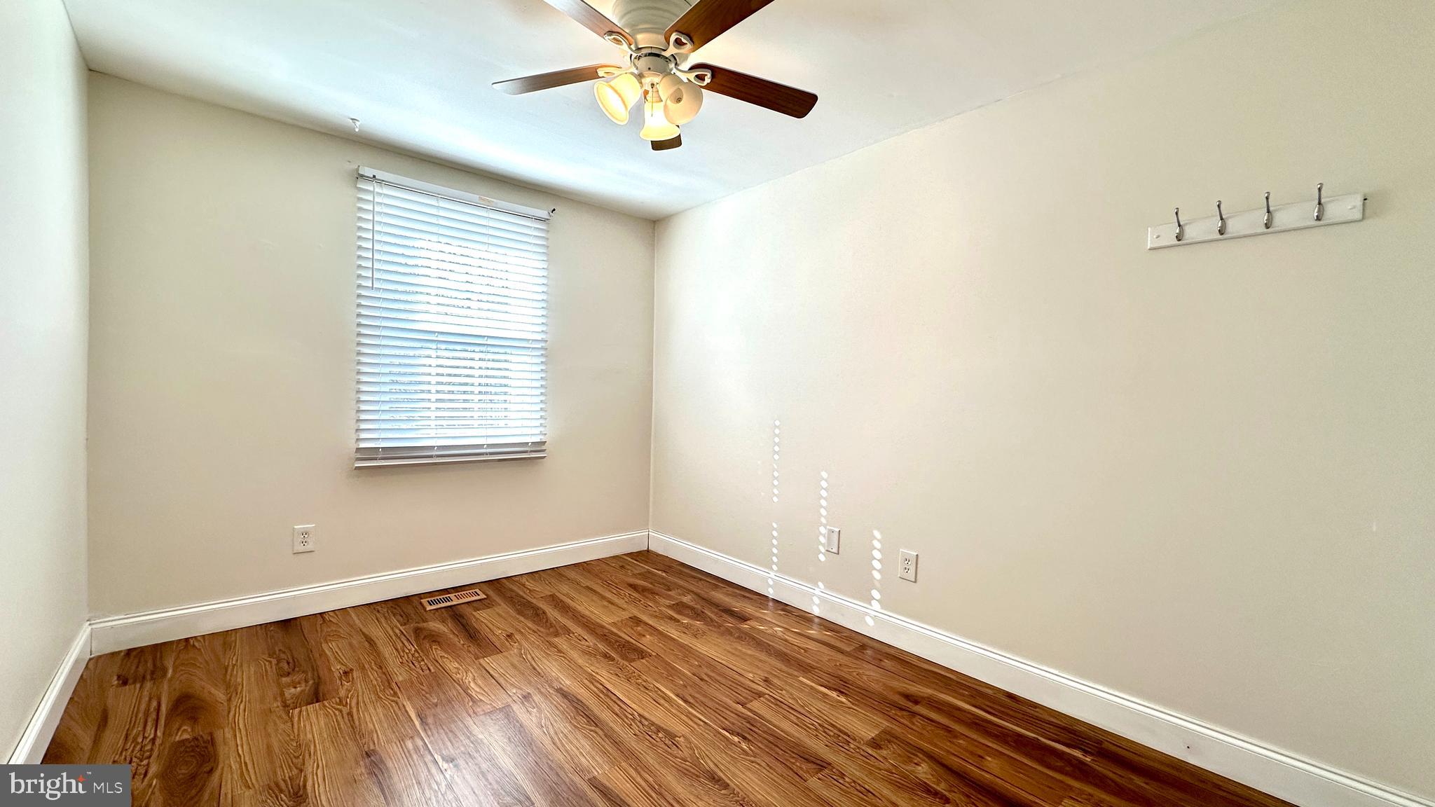 3423 Santee Road Nottingham, MD 21236 - Photo 16 of 30 a view of an empty room with a window and wooden floor