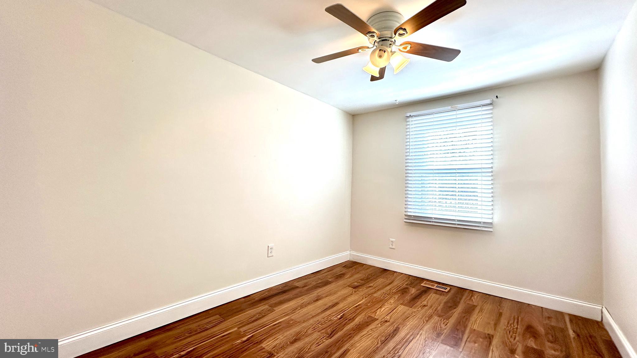 3423 Santee Road Nottingham, MD 21236 - Photo 17 of 30 a view of an empty room with window and a ceiling fan