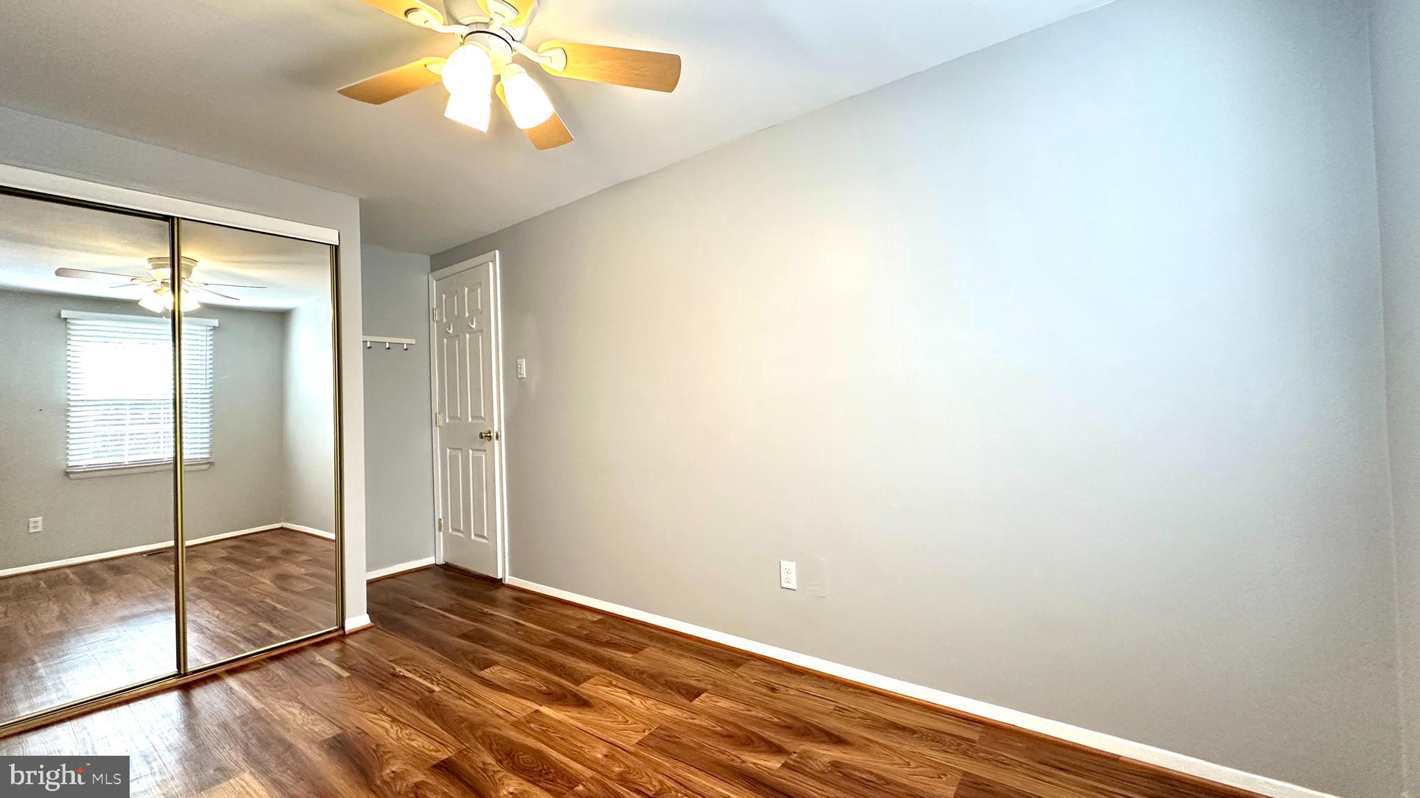 3423 Santee Road Nottingham, MD 21236 - Photo 18 of 30 an empty room with wooden floor and fan