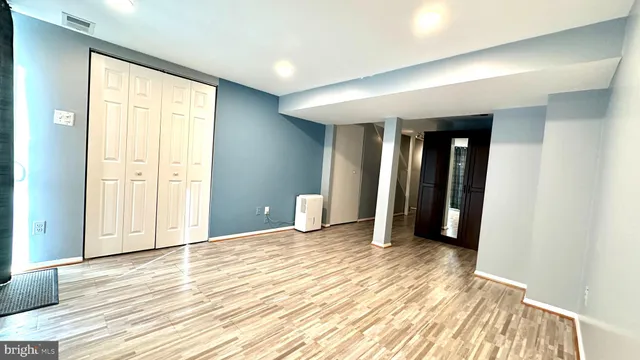 a view of a room with wooden floor and cabinet