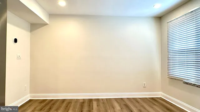 a view of a room with wooden floor