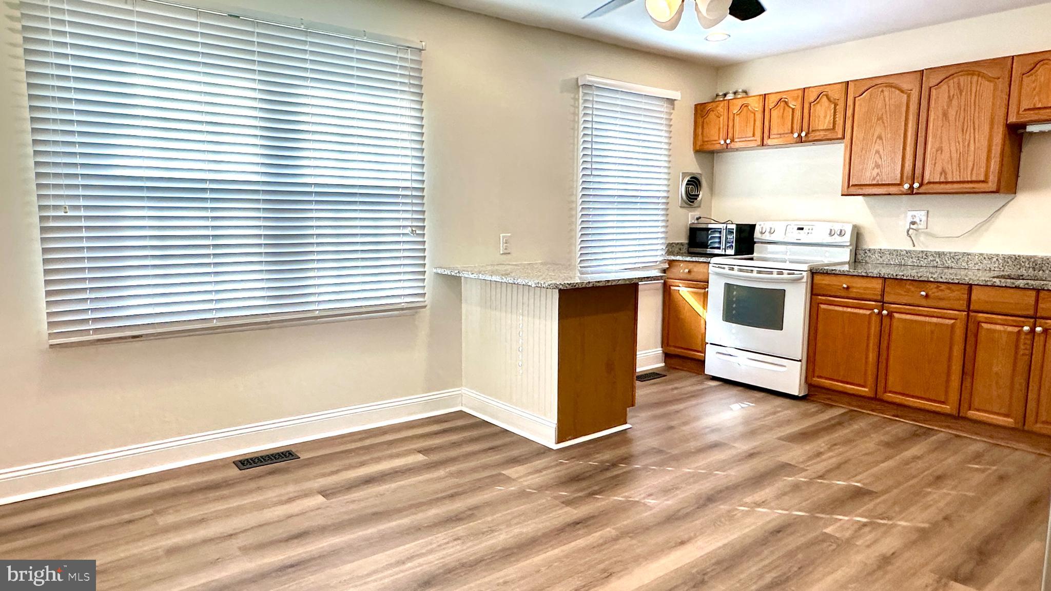 3423 Santee Road Nottingham, MD 21236 - Photo 8 of 30 a kitchen with stainless steel appliances cabinets and a large window