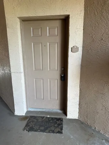 a view of a water pond with boats in front of house