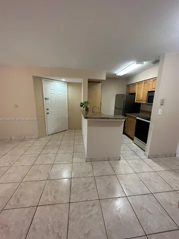 a view of a kitchen with a sink and cabinets