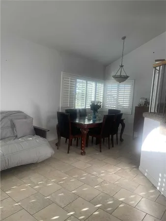 a living room with furniture and a dining table