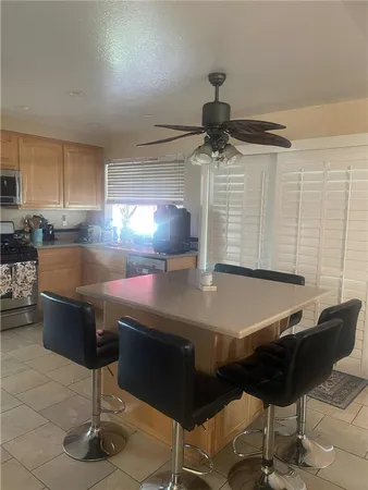 a kitchen with a table chairs and chandelier