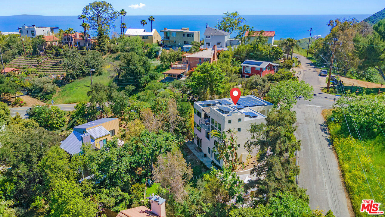 1876 Lookout Road Malibu, CA 90265 - Photo 3 of 48 an aerial view of a house with a yard and lake view