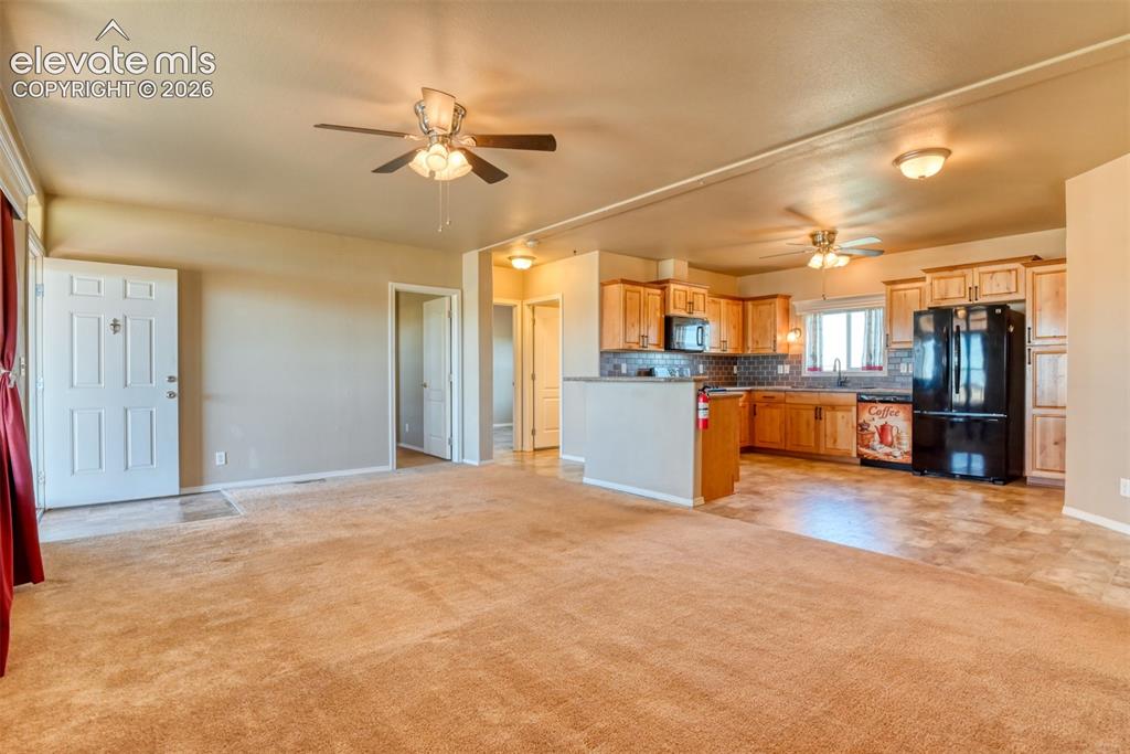 22558 Enoch Road Calhan, CO 80808 - Photo 7 of 50 a view of a kitchen with a stove cabinets and a kitchen