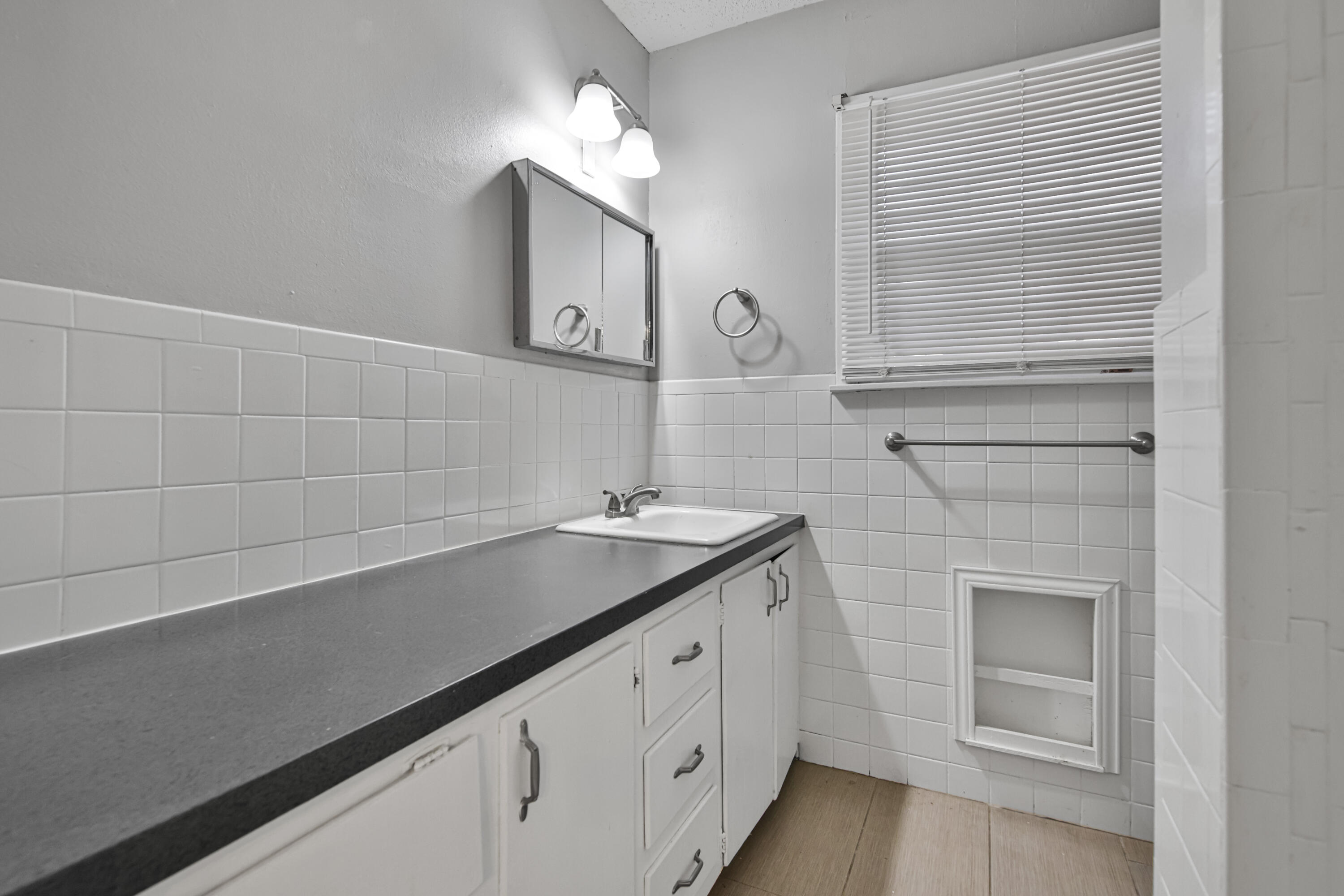 3515 48th Street Lubbock, TX 79413 - Photo 15 of 29 a bathroom with a sink and a mirror
