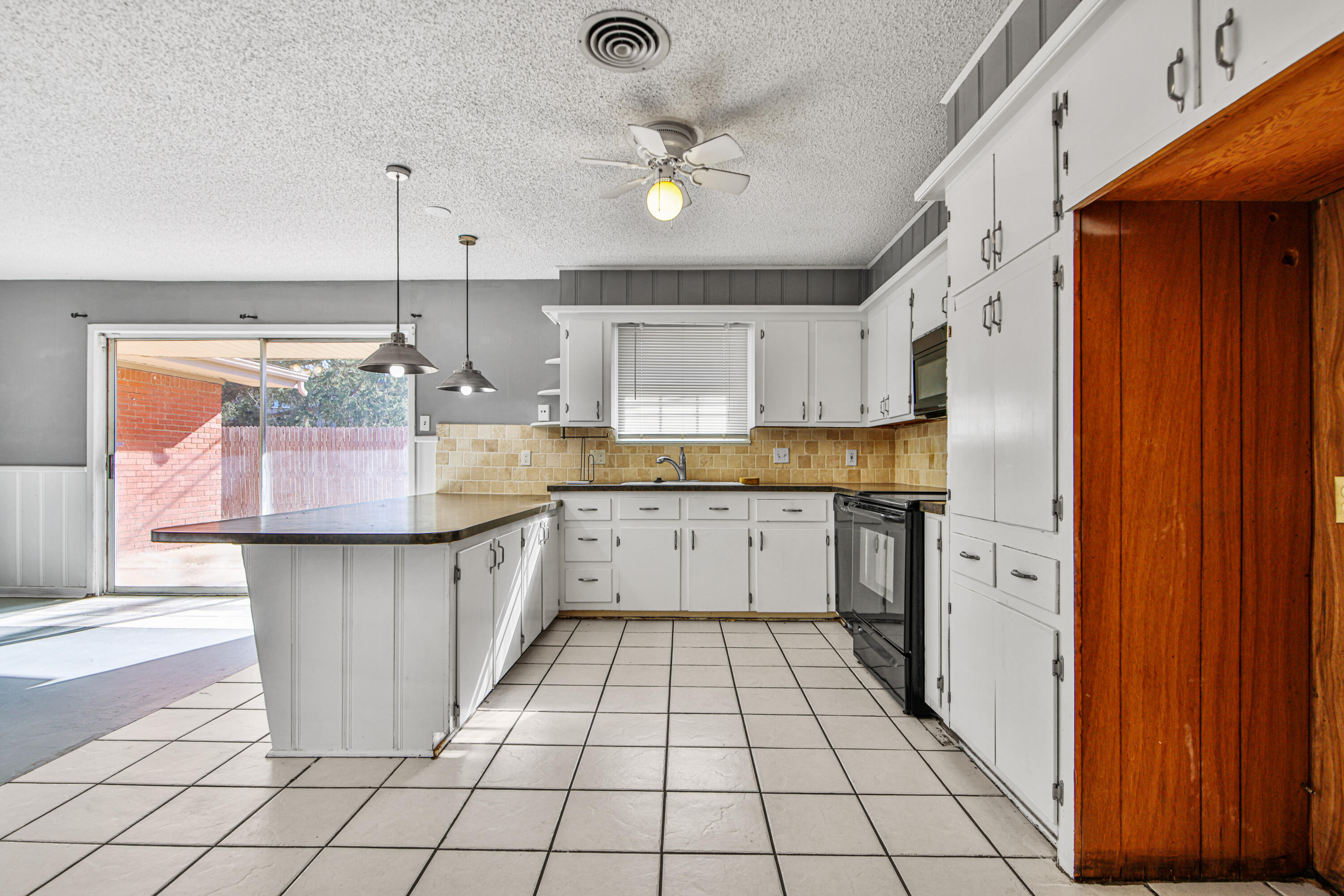 3515 48th Street Lubbock, TX 79413 - Photo 21 of 29 a kitchen with a refrigerator a sink dishwasher and wooden cabinets