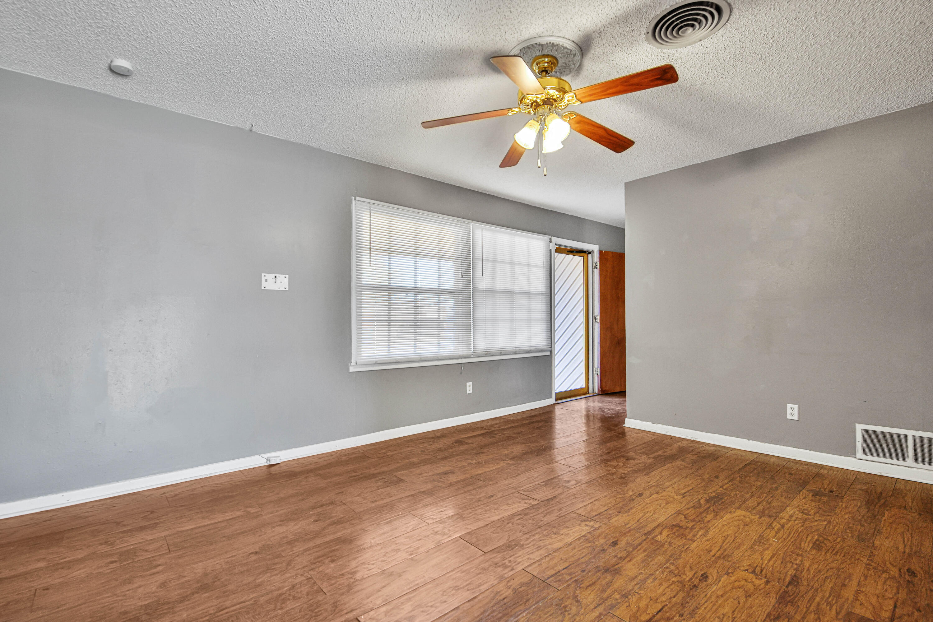 3515 48th Street Lubbock, TX 79413 - Photo 25 of 29 wooden floor in an empty room with a window