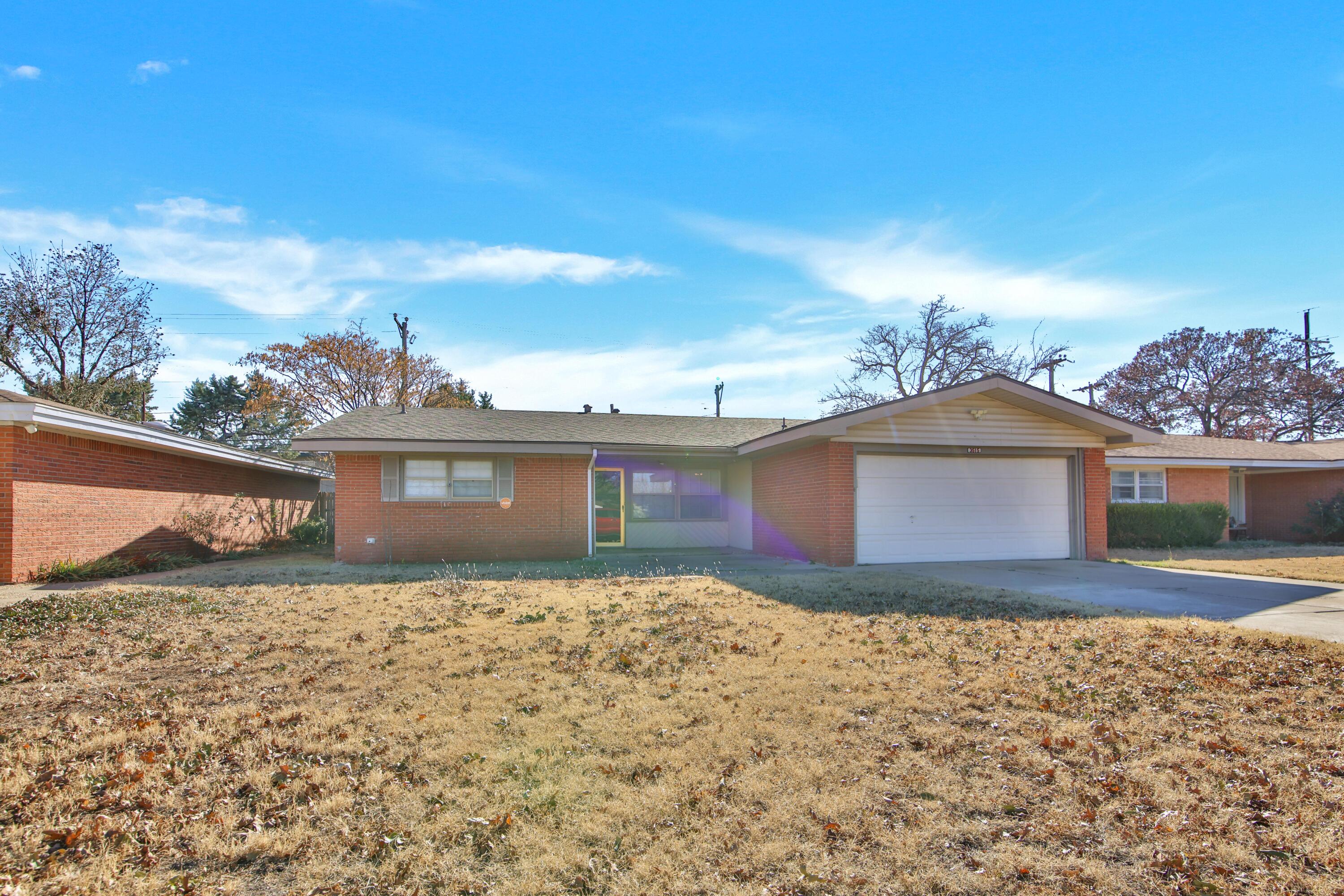 3515 48th Street Lubbock, TX 79413 - Photo 3 of 29 a front view of a house with a yard
