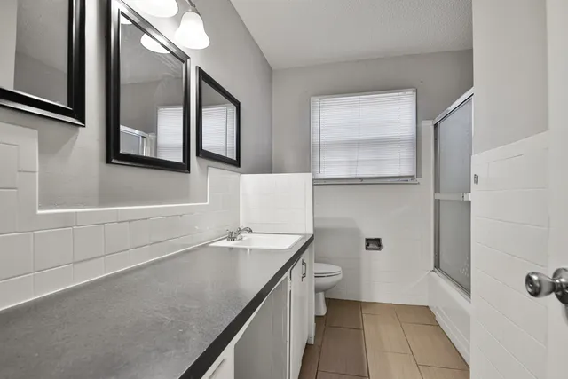 a bathroom with a sink a toilet and a bathtub