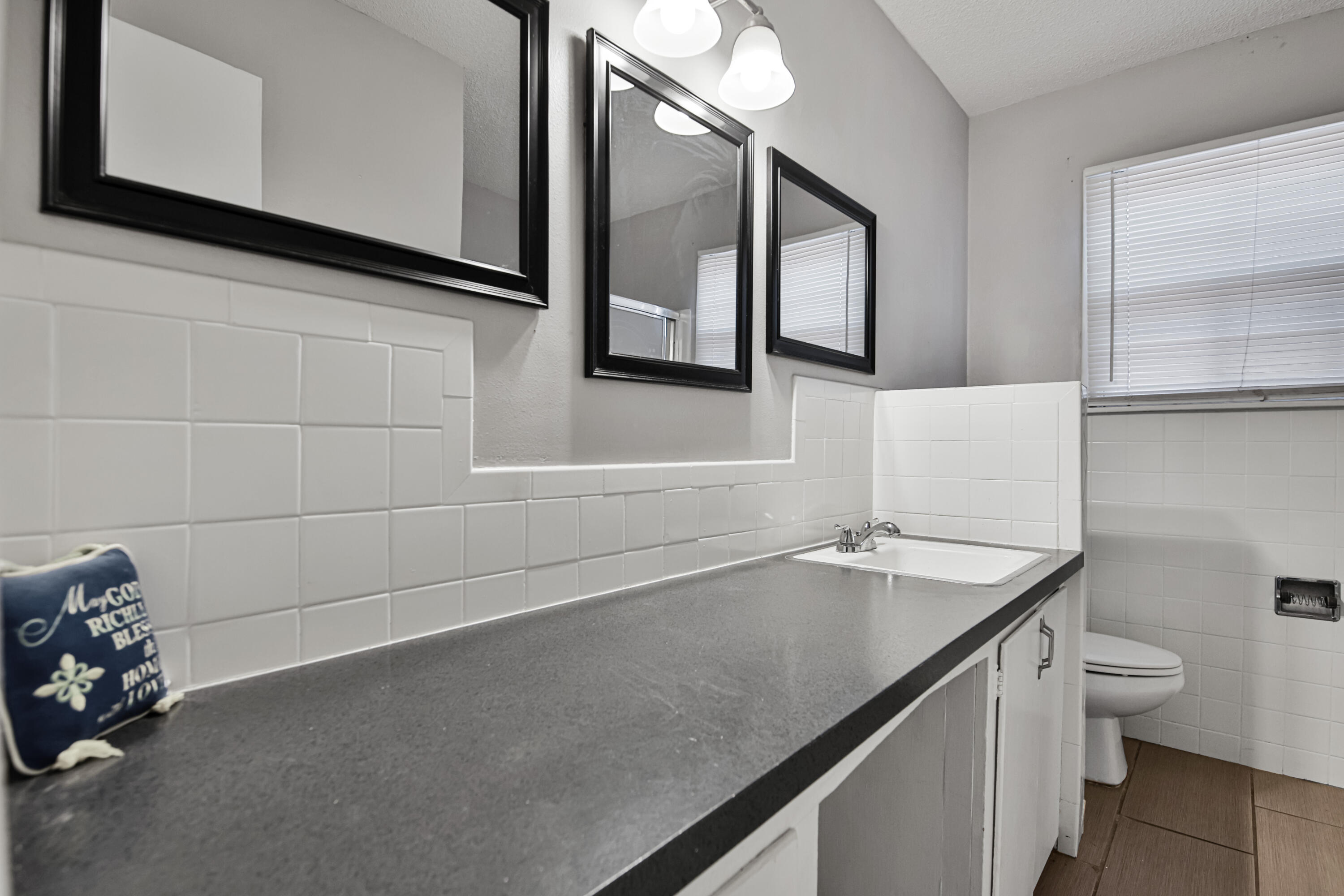 3515 48th Street Lubbock, TX 79413 - Photo 5 of 29 a bathroom with a granite countertop sink and a toilet