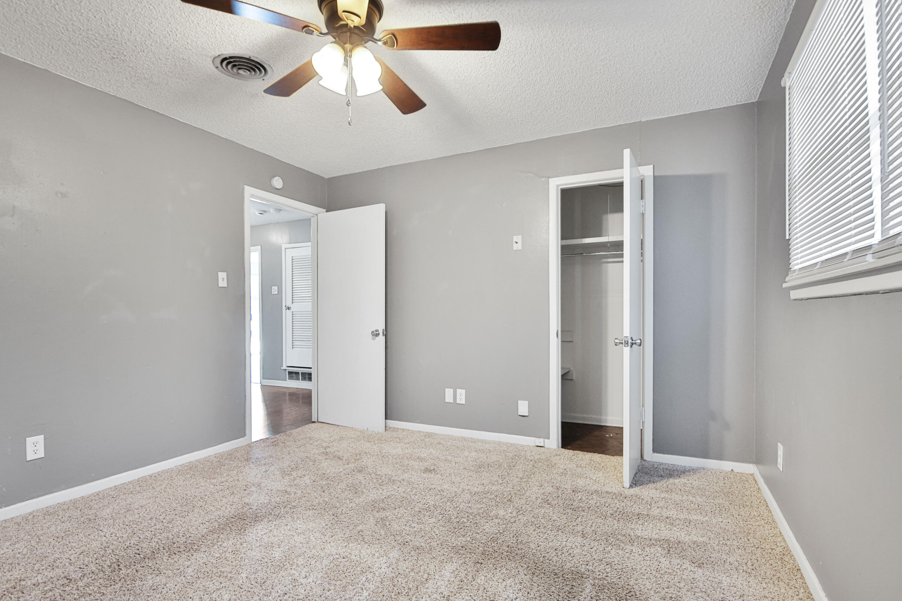 3515 48th Street Lubbock, TX 79413 - Photo 8 of 29 an empty room with chandelier fan and windows