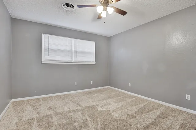 a view of a room with a ceiling fan