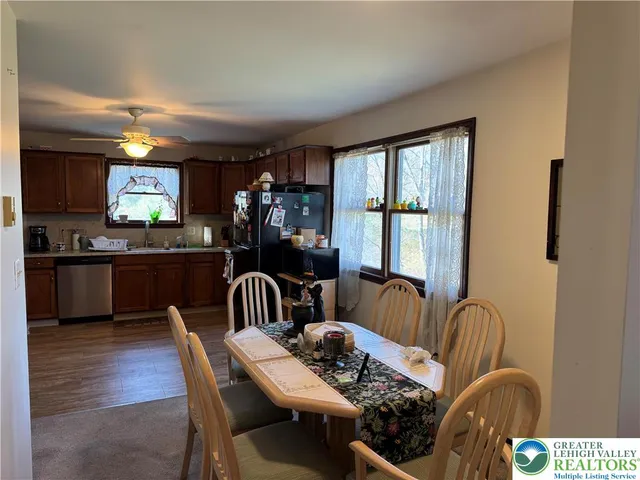 a view of a dining room with furniture window and wooden floor