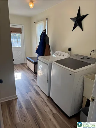 a living room with baby crib furniture and a window