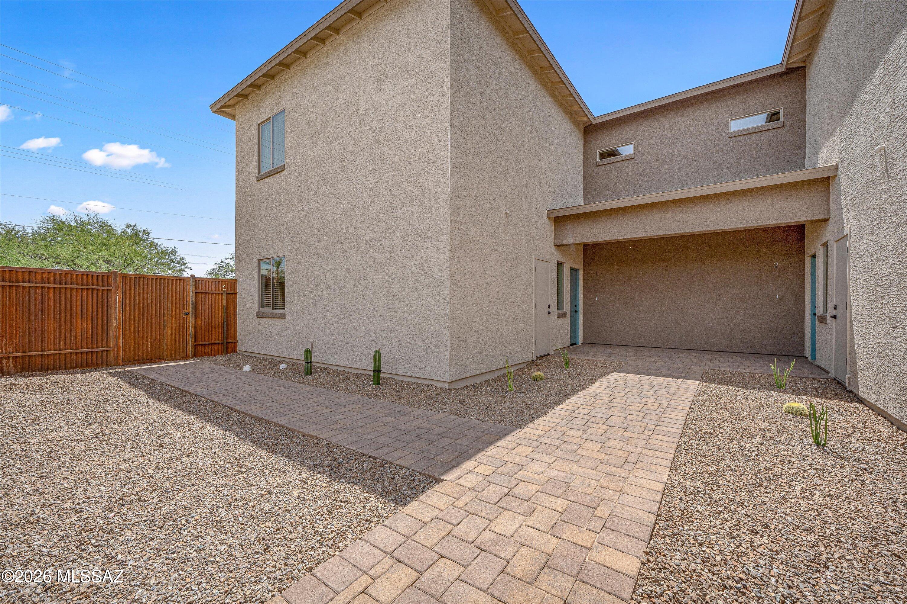 739 North Queen Avenue, Unit 2 Tucson, AZ 85705 - Photo 1 of 28 a front view of a house with a yard