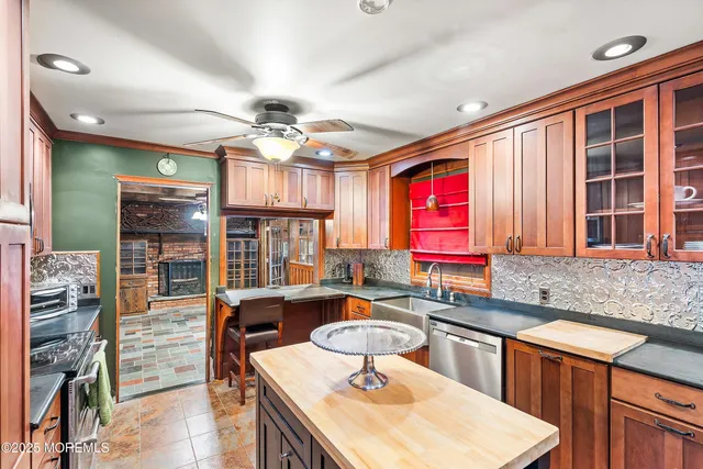 a kitchen with stainless steel appliances granite countertop a sink refrigerator and cabinets