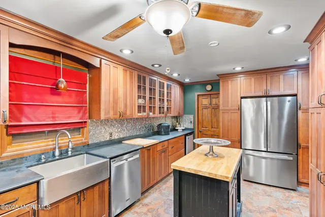 a kitchen with stainless steel appliances a stove microwave and refrigerator
