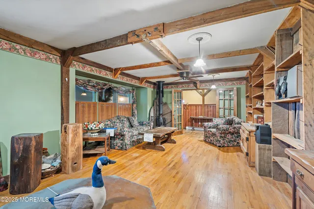 a kitchen with stainless steel appliances granite countertop a stove top oven a sink a dining table and chairs