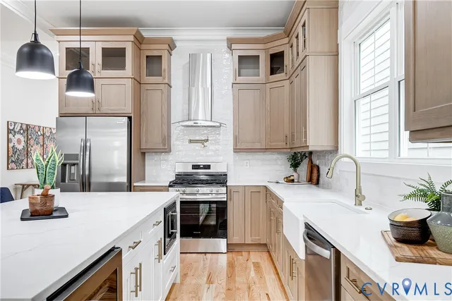 a kitchen with stainless steel appliances a sink stove and cabinets