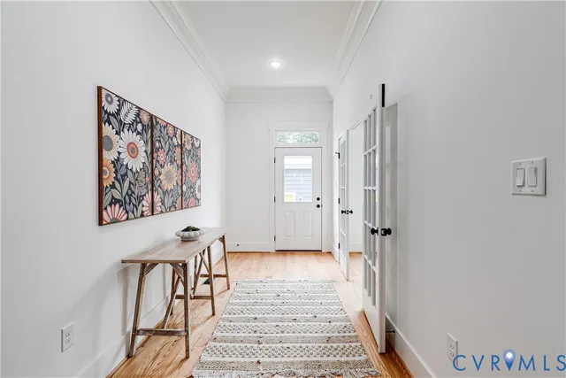 a view of a hallway with paintings on the wall