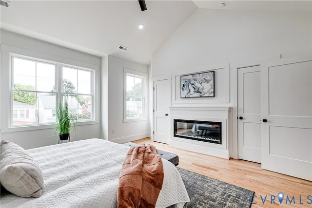 a bedroom with a bed and a fireplace