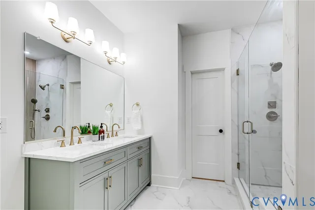 a bathroom with a double vanity sink mirror and shower