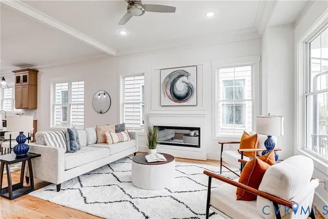 a living room with furniture a fireplace and a large window