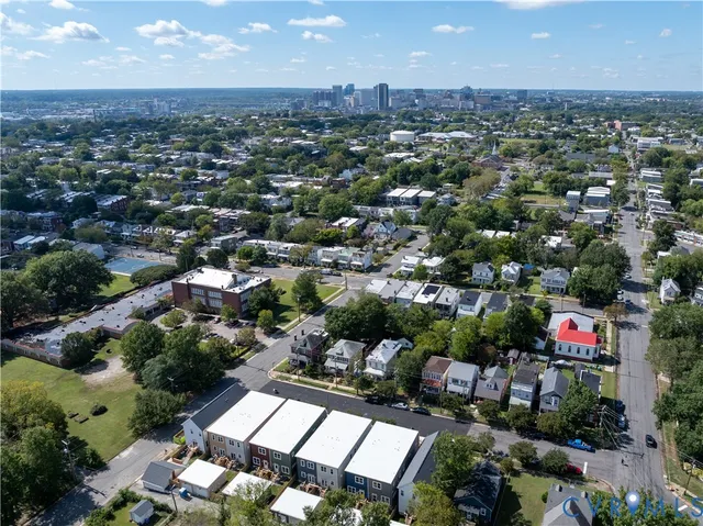 an aerial view of a houses with a yard