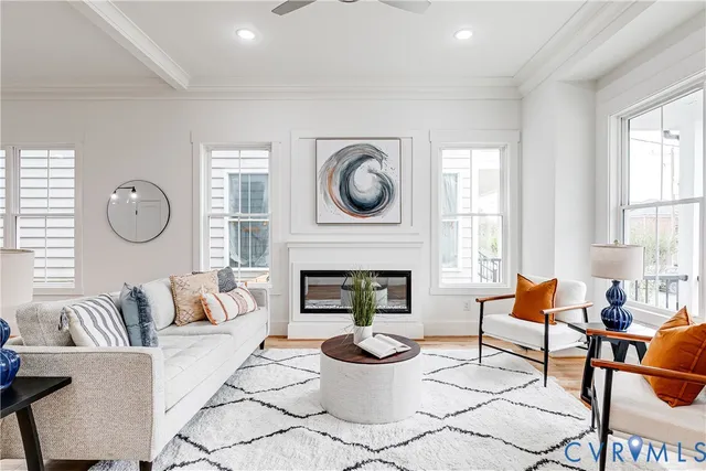 a living room with furniture a fireplace and window