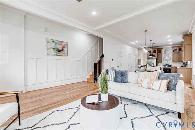 a living room with furniture and a wooden floor