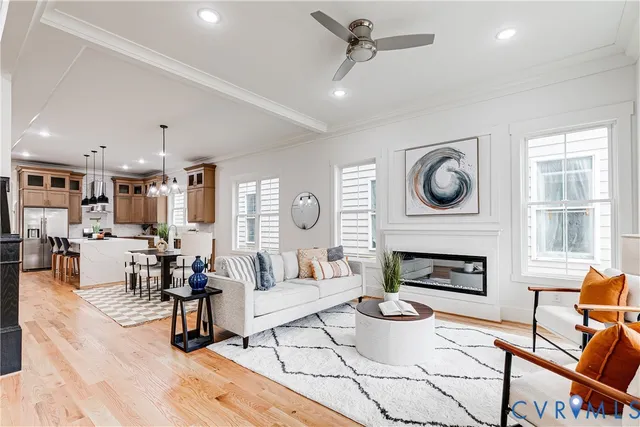 a living room with furniture a clock and a fireplace