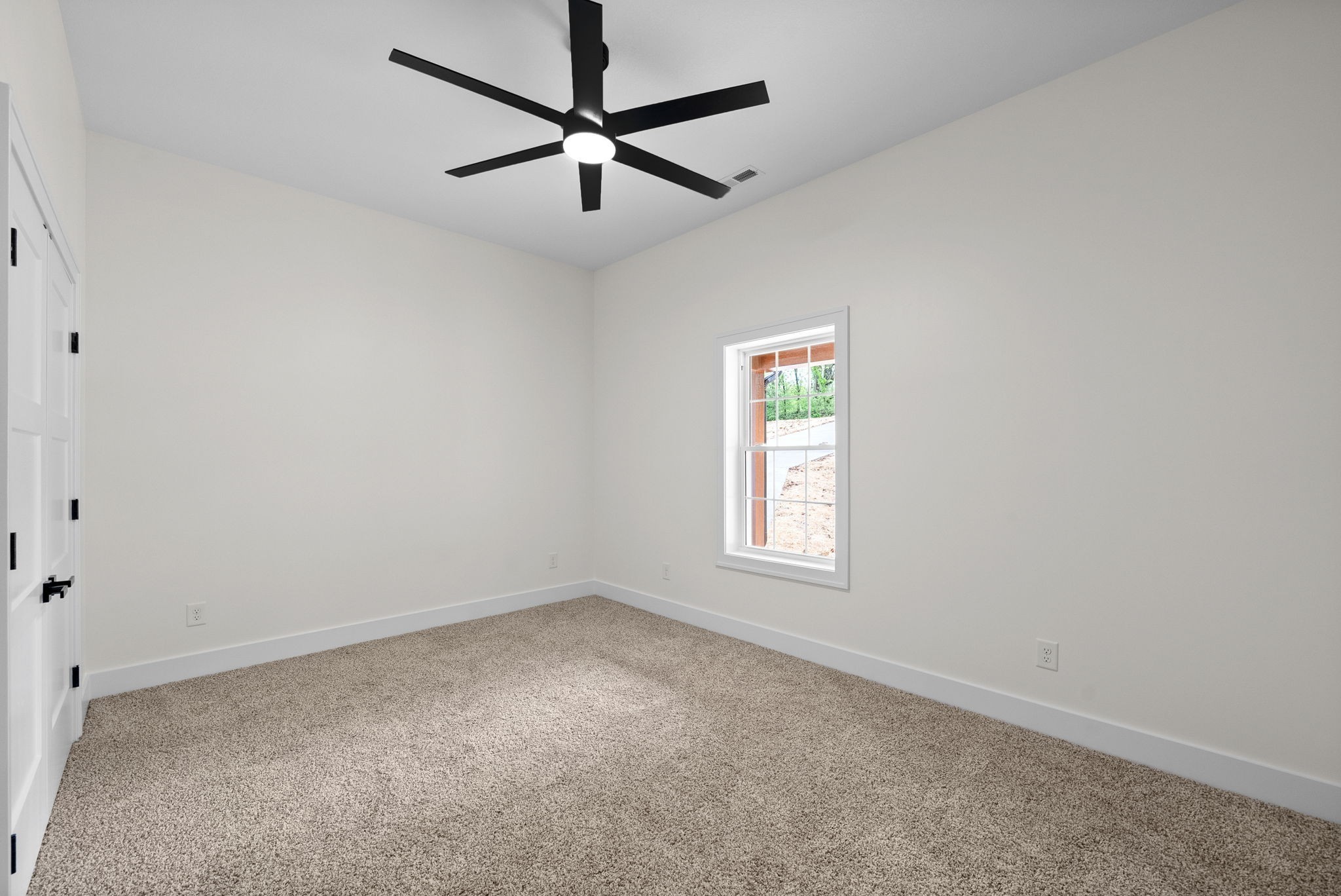 4151 Southside Road Southside, TN 37171 - Photo 11 of 17 an empty room with a window and a fan