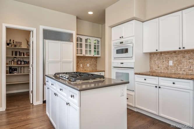 877 Eldorado Drive Superior, CO 80027 - Photo 12 of 34 a kitchen with white cabinets and appliances