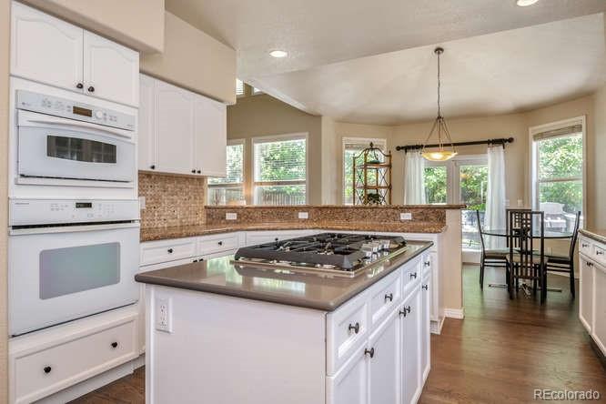877 Eldorado Drive Superior, CO 80027 - Photo 13 of 34 a kitchen with stainless steel appliances granite countertop a stove a sink and a microwave