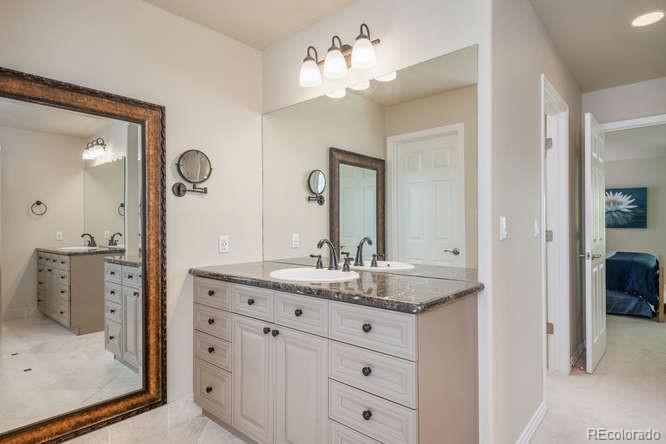 877 Eldorado Drive Superior, CO 80027 - Photo 18 of 34 a bathroom with a double vanity sink and a mirror