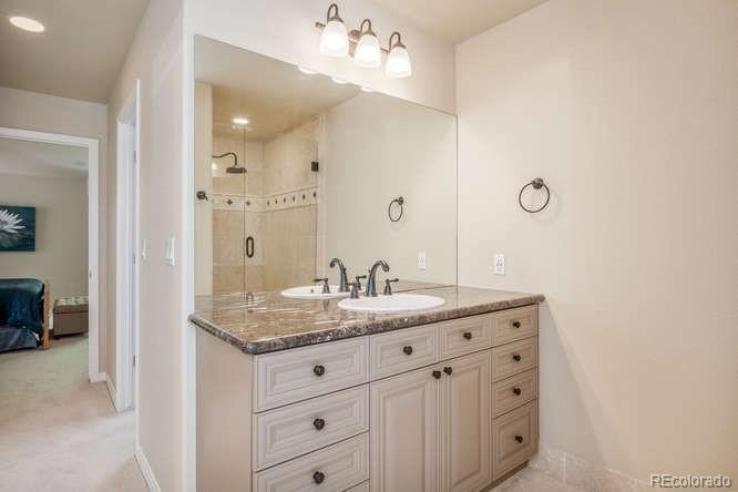 877 Eldorado Drive Superior, CO 80027 - Photo 19 of 34 a bathroom with a granite countertop sink and a mirror