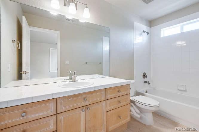 877 Eldorado Drive Superior, CO 80027 - Photo 24 of 34 a bathroom with a toilet a sink a mirror a bathtub and vanity