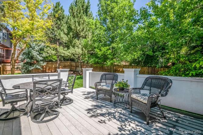877 Eldorado Drive Superior, CO 80027 - Photo 28 of 34 a view of a patio with table and chairs with wooden floor and fence