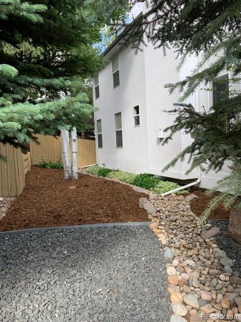 877 Eldorado Drive Superior, CO 80027 - Photo 34 of 34 a view of a white house with a yard and plants