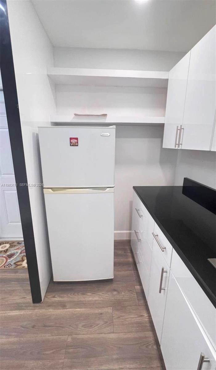 13030 Southwest 84th Street, Unit B Miami, FL 33183 - Photo 4 of 10 a view of a kitchen with refrigerator and cabinets