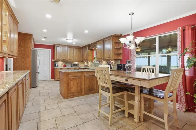 a view of a livingroom with a dinning table and chandelier