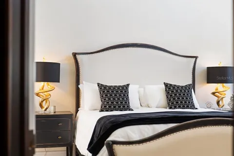 a spacious bathroom with a granite countertop sink a large mirror and a window