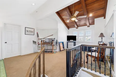 a view of a house with a yard and potted plants